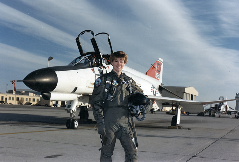 Eileen Collins in front of an F4
