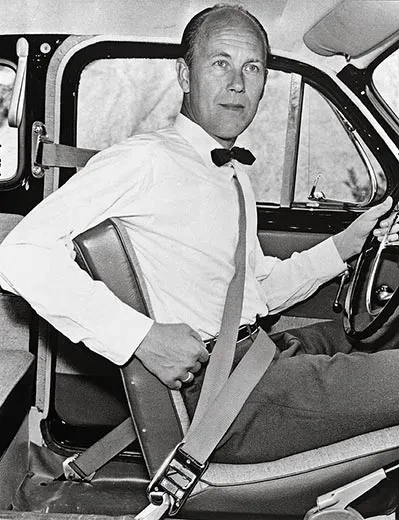 Nils Bohlin showeing off a three-point seatbelt